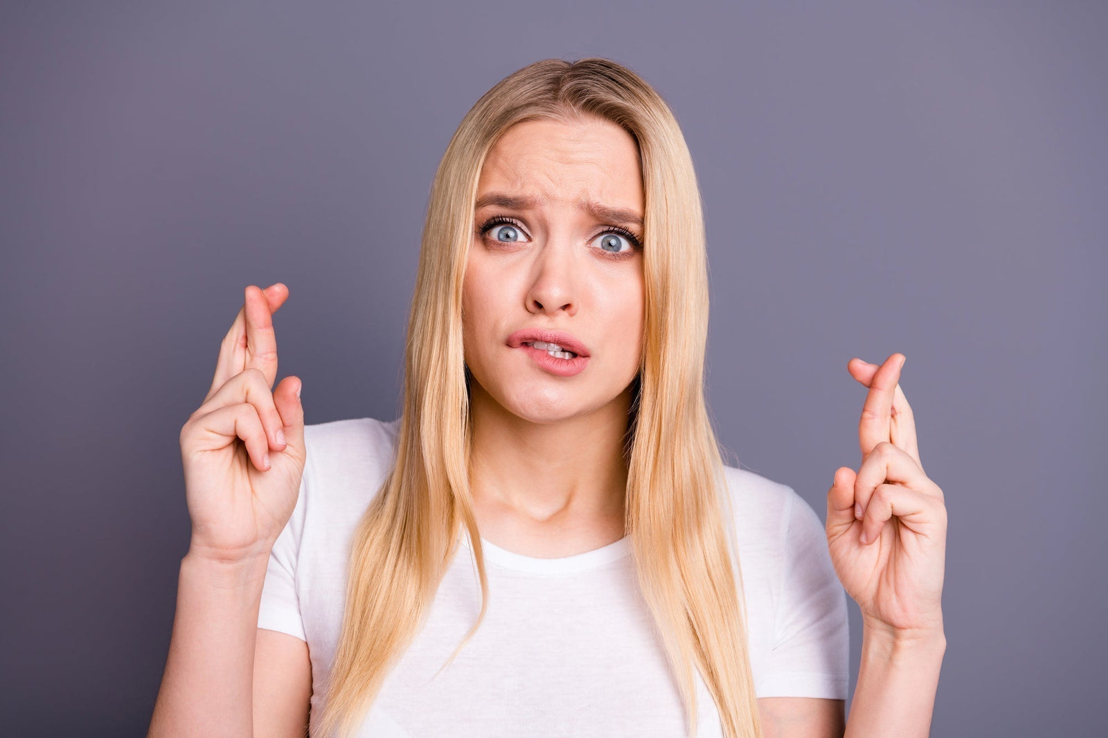 Women crossing her fingers hoping her cheap skincare works | Affordable Skincare: Avoiding Long-Term Costs of Cheap Products | Parisians Pure Skincare