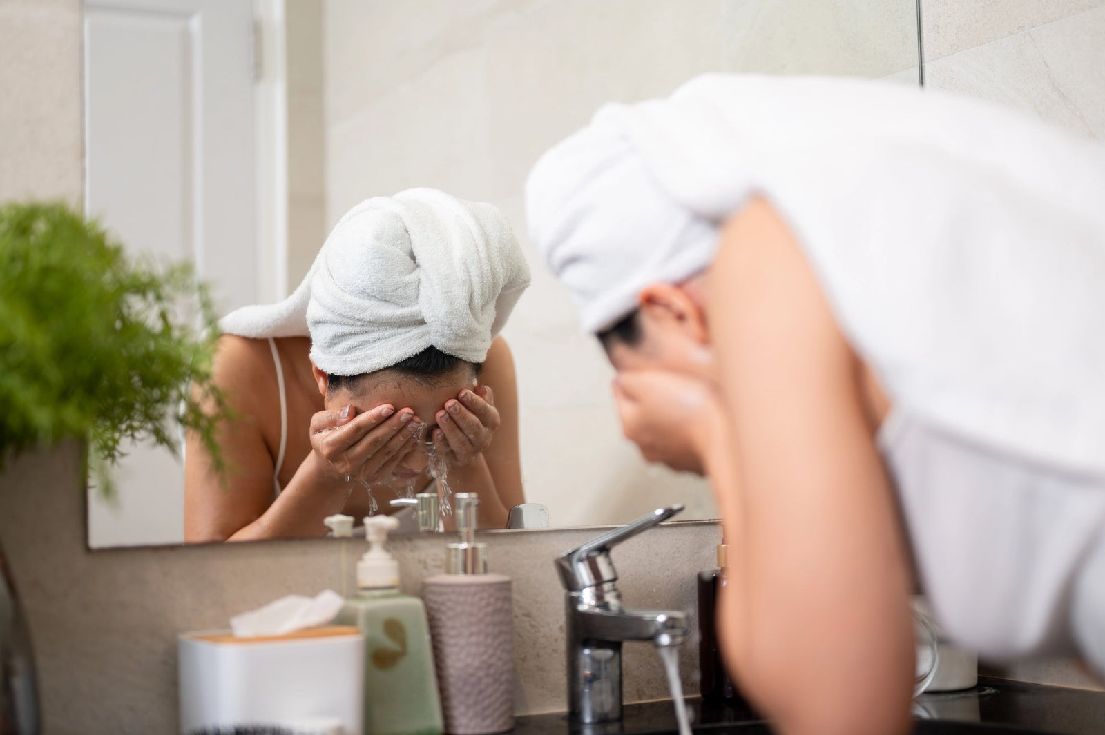 Woman washing face near sink | Best Face Cleanser for Sensitive, Mature Skin: Reviews & Recommendations | Parisians Pure Skincare