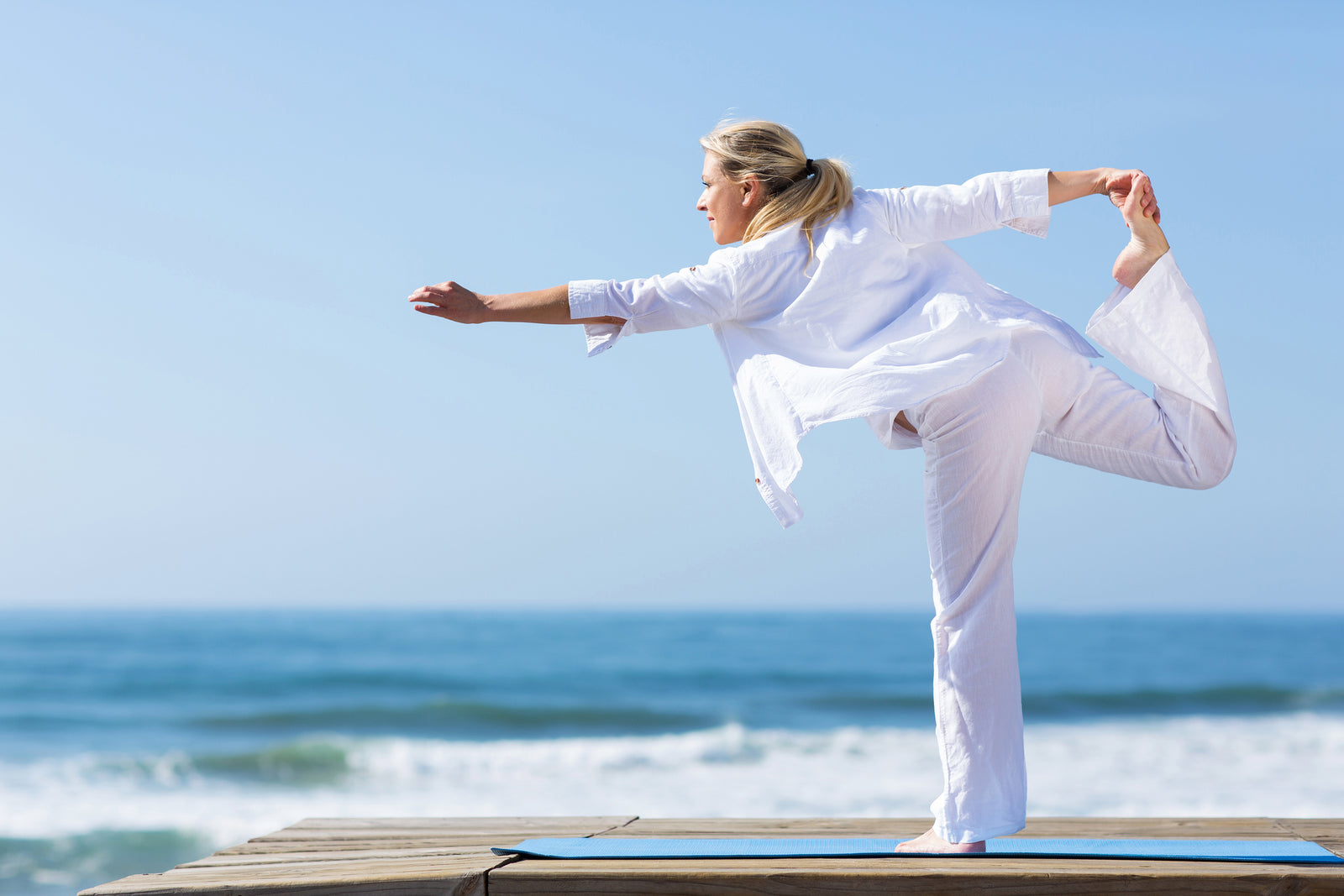 Woman doing yoga at the beach | Parisians Pure Indulgence
