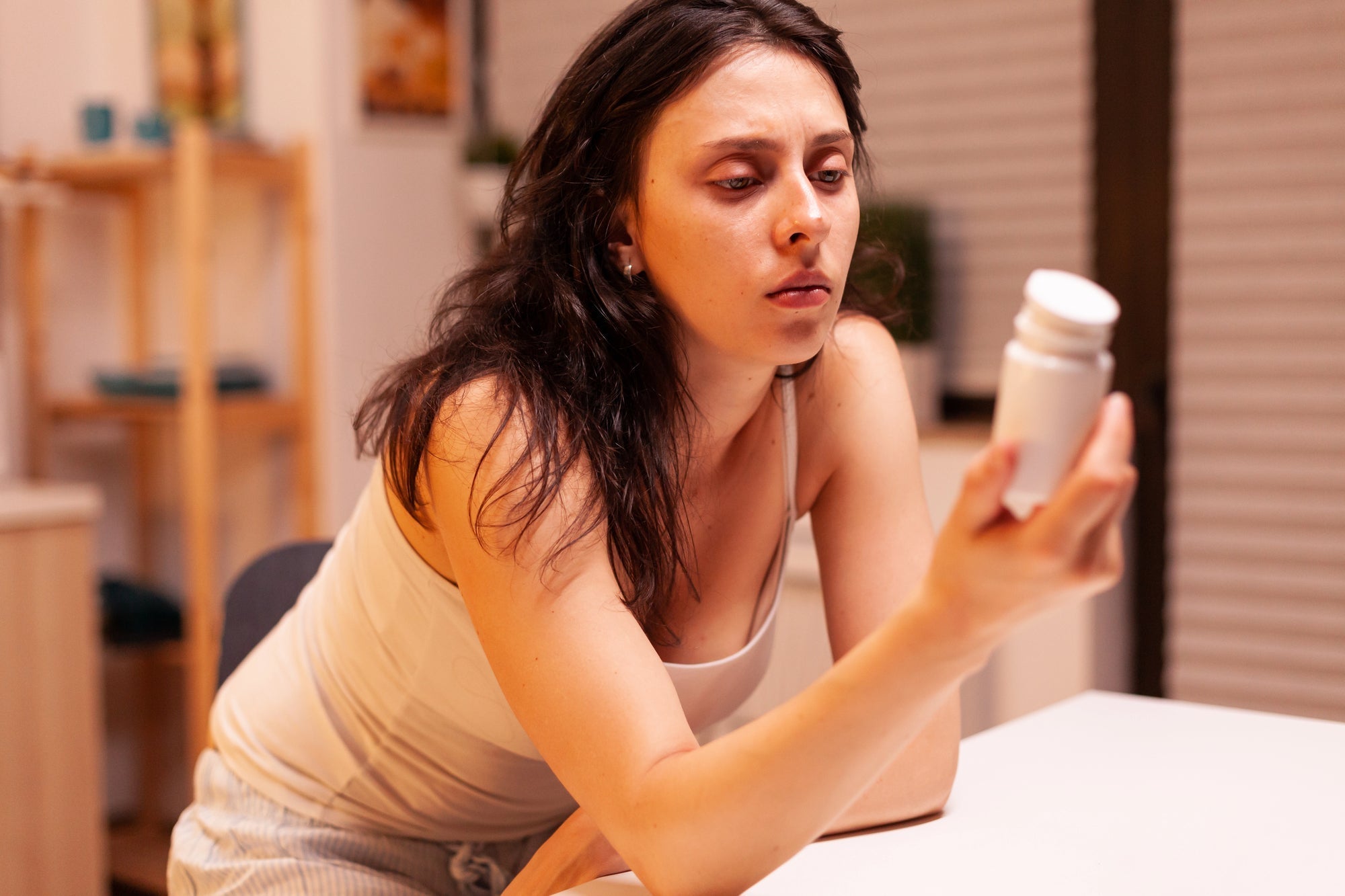 woman looking at a bottle | Why your skincare is failing: The crucial rules for product storage (and the 77 F limit) | Parisians Pure Skincare