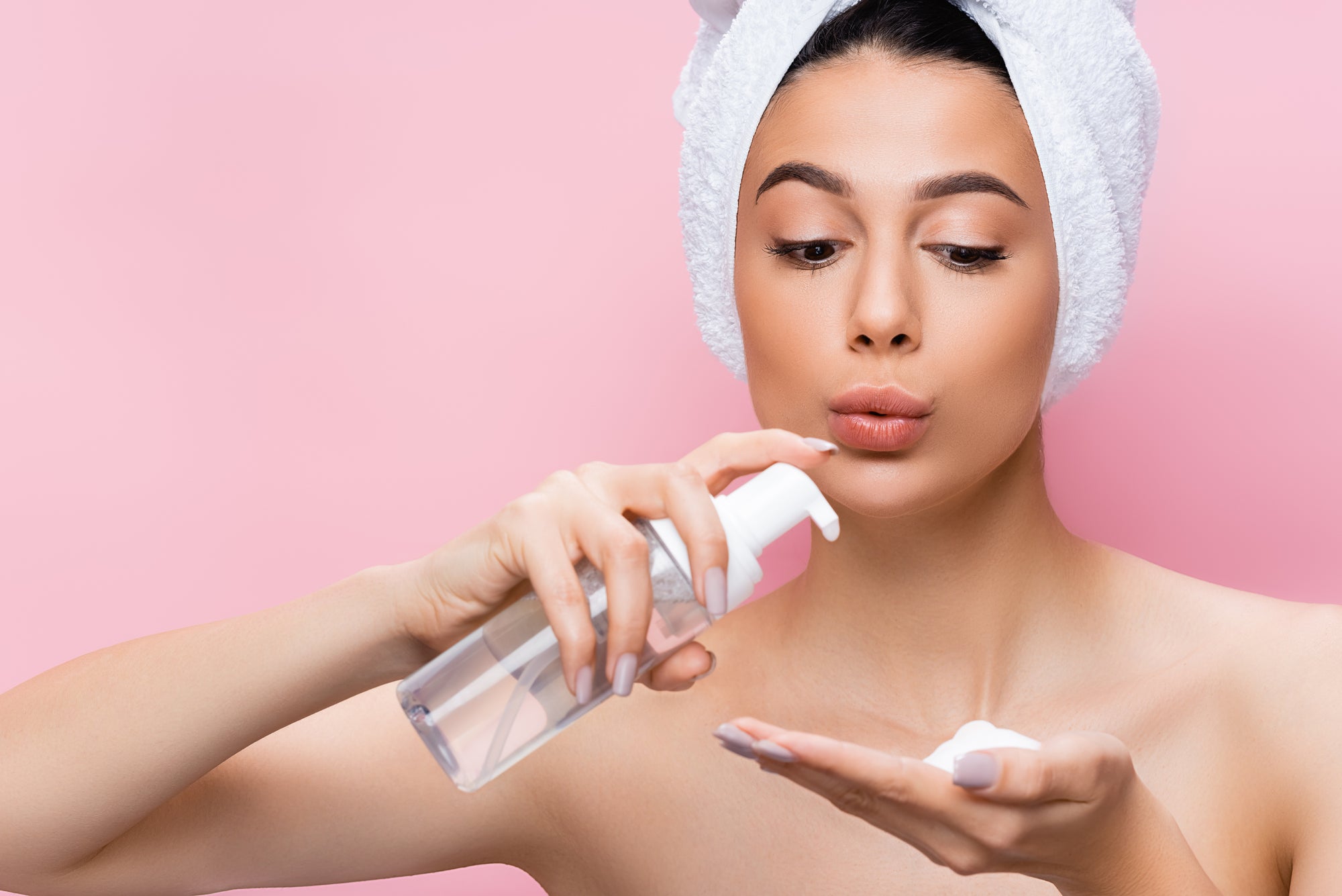 Woman about to apply a foaming face cleanser | The-Double-Cleanse-Dilemma-Unveiling-the-Necessity-Behind-Removing-Sunscreen | Parisians Pure Indulgence