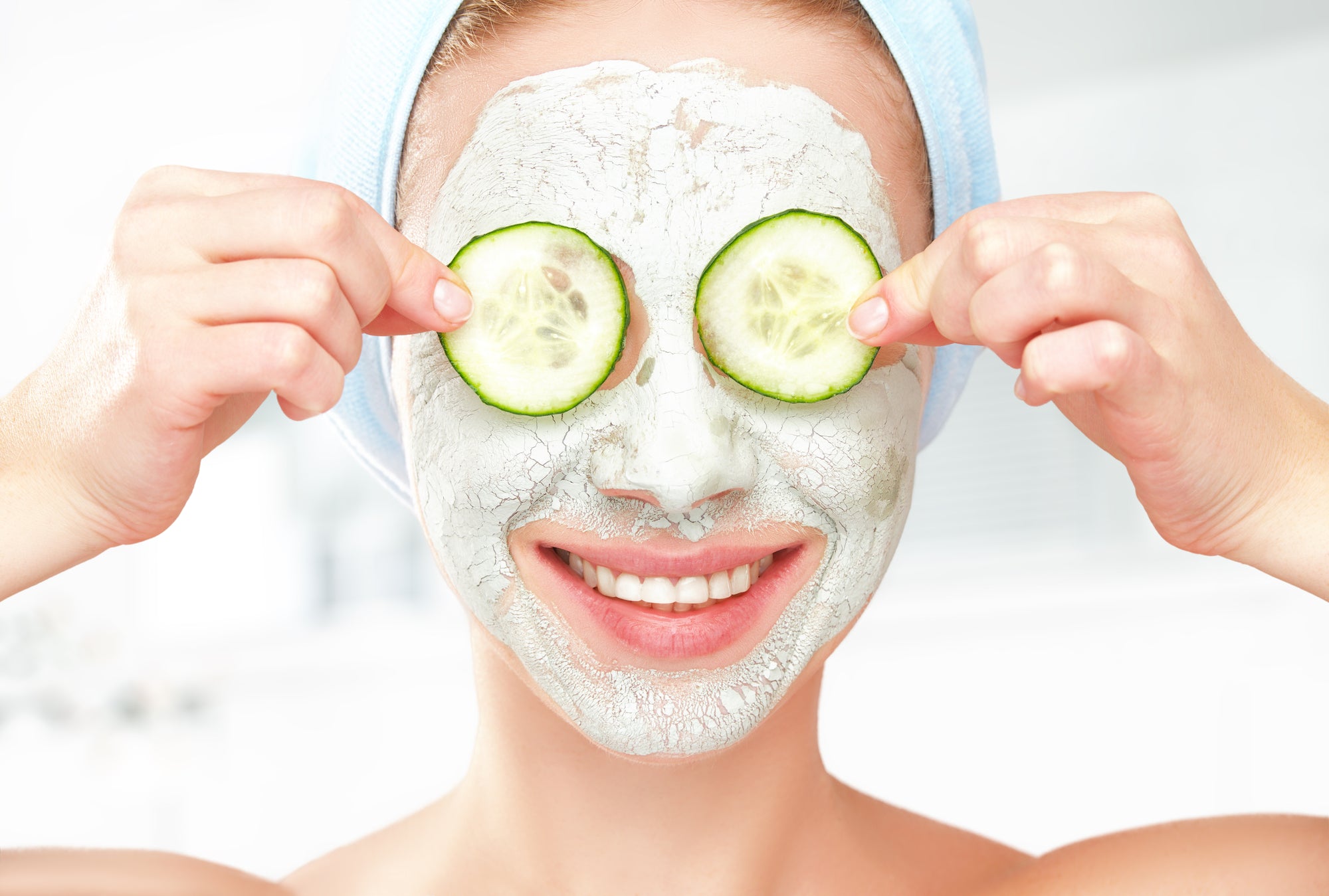 Women with face mask and cucumbers on her eyes-Give yourself a spa-like facial at home in 5 easy steps