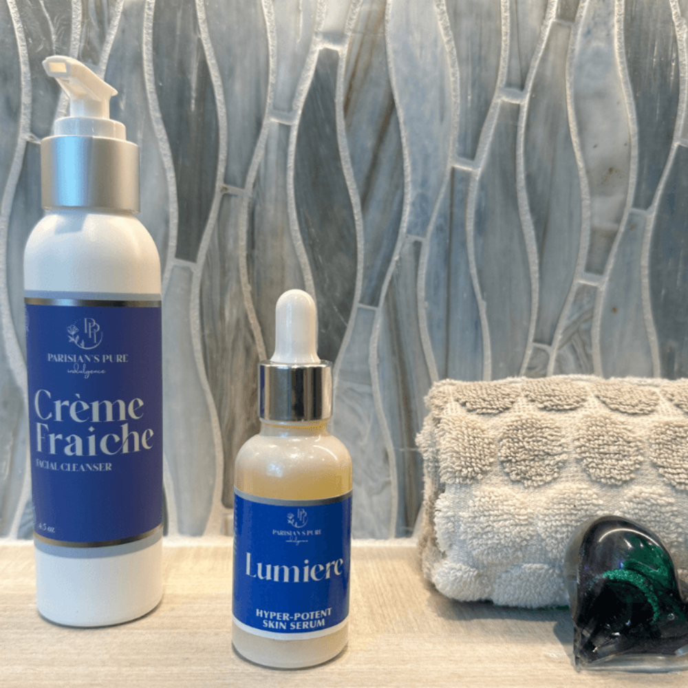 lumiere-mature-skin-serum-creme fraiche cleanser together with cloth against blue gray background